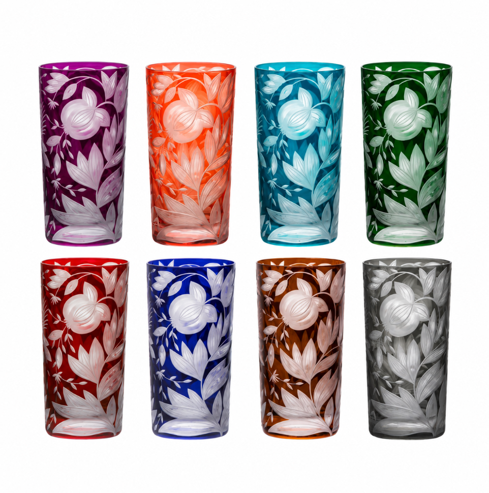 Eight Artel Verdure Highball Jewel Colors crystal glasses in different jewel tones, each featuring an etched floral pattern of pomegranates and leaves.