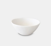 The Tina Frey Sculpt Tapered Bowl White is a hand-sculpted, ceramic bowl with an organic, slightly irregular shape, shown on a light gray background.