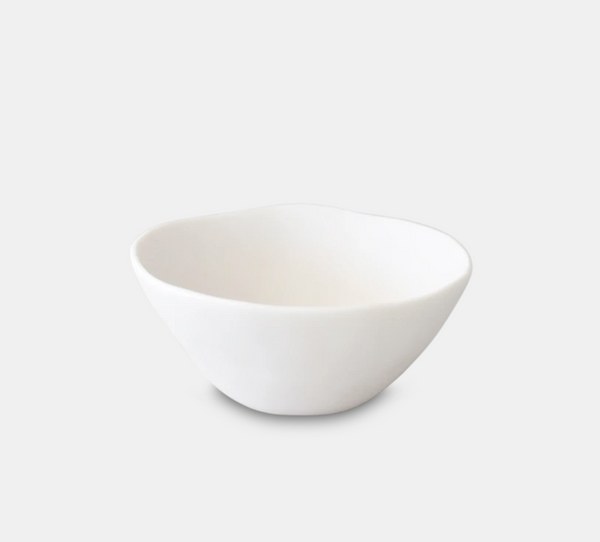 The Tina Frey Sculpt Tapered Bowl White is a hand-sculpted, ceramic bowl with an organic, slightly irregular shape, shown on a light gray background.