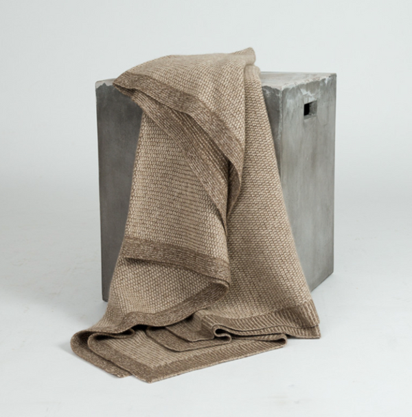 Hangai Mountain Textiles Beehive Cashmere & Yak Throw - Beige & Cappuccino knit blanket draped over a gray block.