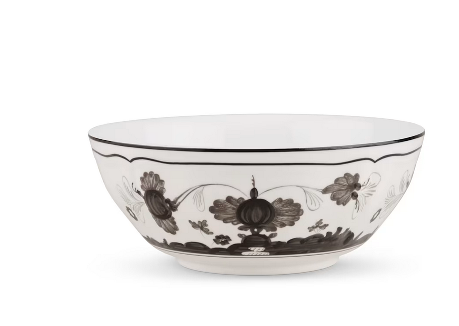 The Oriente Italiano Dinnerware Albus by Ginori 1735, a handcrafted white bowl with black floral patterns and a black rim, is displayed elegantly on a white background.