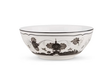 The Oriente Italiano Dinnerware Albus by Ginori 1735, a handcrafted white bowl with black floral patterns and a black rim, is displayed elegantly on a white background.