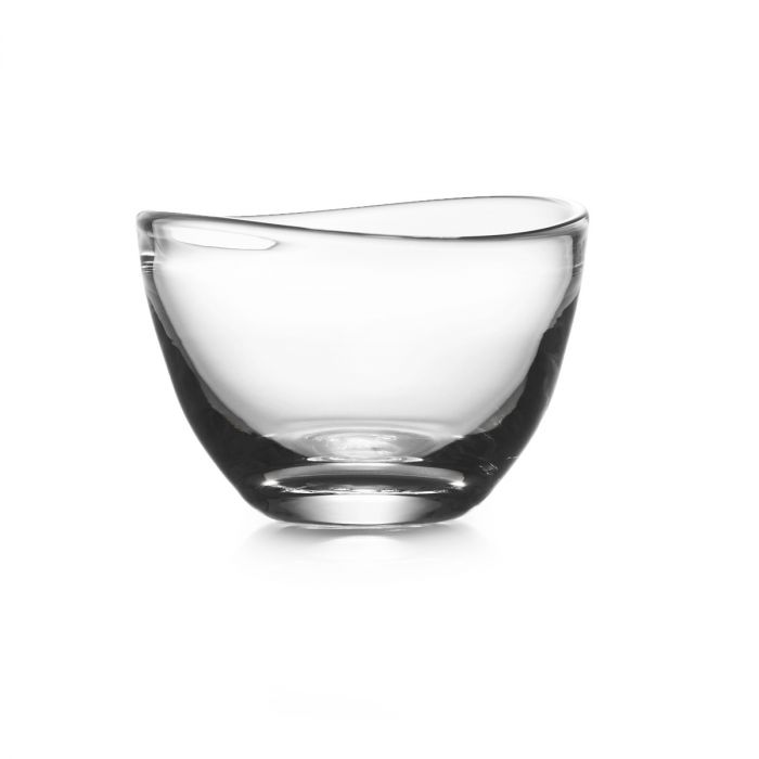 The Simon Pearce Barre Bowl is a clear, shallow, curved glass bowl displayed on a white background, showcasing contemporary design and the timeless elegance of Simon Pearce glassware.