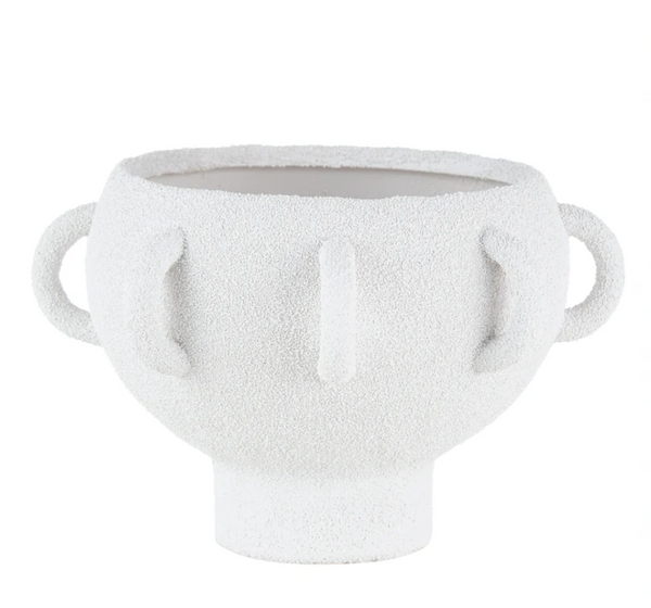 The BT- Shalom Textured Vessel White features a wide round porcelain body, two looped side handles, three vertical raised lines on the front, and a short cylindrical base.