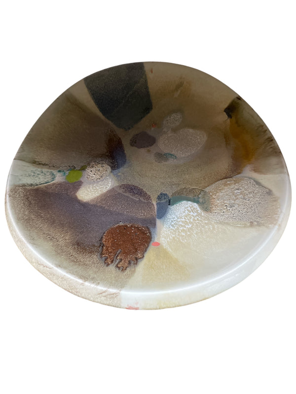 The KleinReid Rio Abrico Platter X Large is a round, hand-painted ceramic piece from the Rio Collection, showcasing an abstract multicolored glaze in earthy browns, beige, gray, blue, and green on white—a unique find for ceramic lovers.