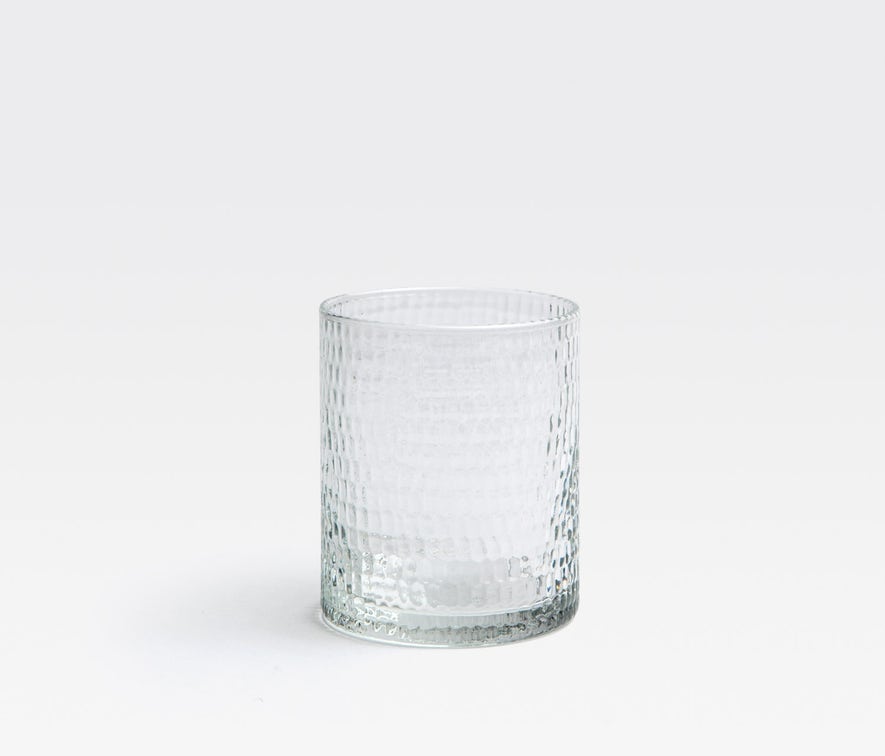 The Blue Pheasant Duncan Glassware Clear tumbler, featuring a hand-blown, dimpled texture, is showcased on a plain white background—ideal for everyday use.