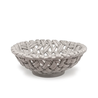 The Skyros Woven Basket - Round-15" is a glossy, light gray ceramic bowl with an open lattice design, resembling a handwoven basket, displayed on a plain white background.