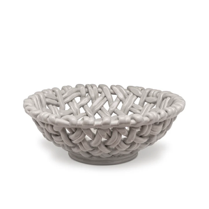 The Skyros Woven Basket - Round-15" is a glossy, light gray ceramic bowl with an open lattice design, resembling a handwoven basket, displayed on a plain white background.