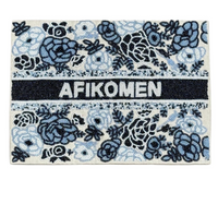 The Lyss & Kat Floral Afikoman Cover - Blue Mix features "AFIKOMEN" in white on a black beaded strip, with blue and black beaded floral designs on a light background—ideal for your Passover Seder.