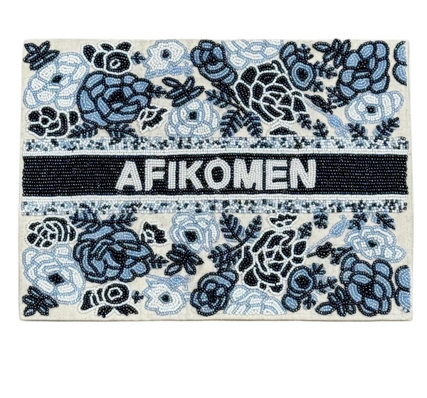 The Lyss & Kat Floral Afikoman Cover - Blue Mix features "AFIKOMEN" in white on a black beaded strip, with blue and black beaded floral designs on a light background—ideal for your Passover Seder.
