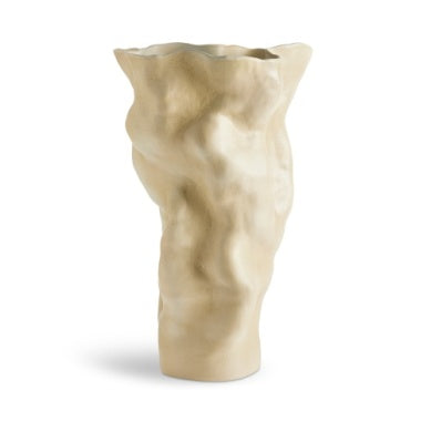 The Timna Vase Latte - Tall by L'Objet is a beige ceramic vase featuring an organic, wavy texture inspired by the Arava desert, reminiscent of ancient porcelain vessels shaped by time and nature.