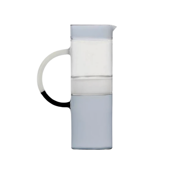 The Ichendorf Milano Tequila Sunrise Cylinder Pitcher features a minimalist, modern design with a clear rectangular upper section, light gray base, and a rounded black-accented handle. Photographed against a white background.