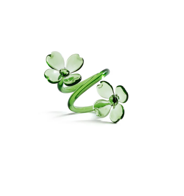 Introducing the Botanica Napkin Ring set of 4 by Zodax—a set of translucent green borosilicate glass rings, each featuring two four-petal flower shapes connected by a curved band. These elegant pieces bring the beauty of glass floral napkin rings and botanical table decor to your dining experience.