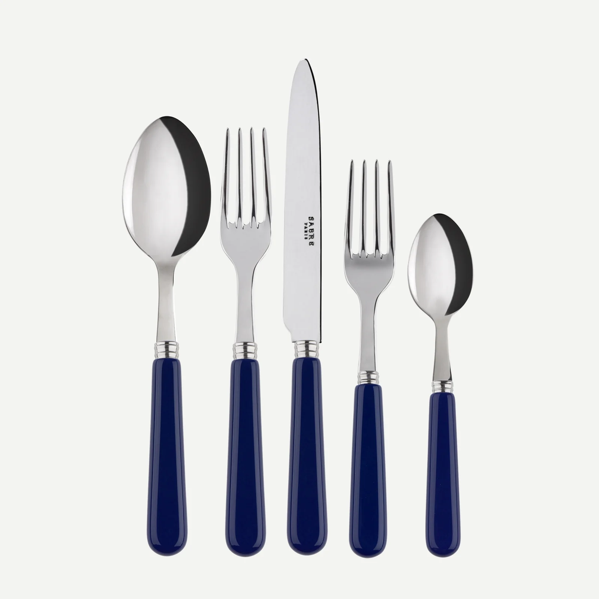 The Sabre Basic Flatware 5 Piece Setting by Sabre features stainless steel utensils with blue acrylic handles—tablespoon, dinner fork, dinner knife, salad fork, and teaspoon—displayed side by side on a white background.