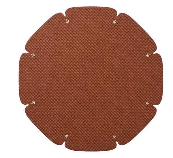 The Divot Placemat Set of 4 by Kim Seybert features flat, brown, textured circular mats with six curved edges and tan stitches near each curve, shown arranged on a white background.