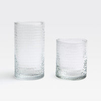 Two Duncan Glassware Clear tumblers by Blue Pheasant sit on a white background. One is tall and cylindrical, the other short and wide—both featuring textured, hand-blown glass ideal for everyday use.