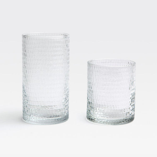 Two Duncan Glassware Clear tumblers by Blue Pheasant sit on a white background. One is tall and cylindrical, the other short and wide—both featuring textured, hand-blown glass ideal for everyday use.