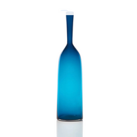 The Angelic Bottle - Small - by Cariati is a tall, slender blue glass bottle with a long neck and a white pump dispenser, standing upright against a plain white background.