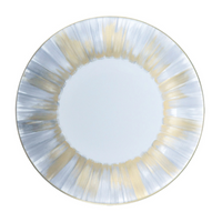 The Marie Daage Panache plate by Marie Daâge features a white Limoges porcelain center and a rim with metallic gold and silver brushstrokes, creating a shimmering effect—ideal for lovers of luxury dinnerware.