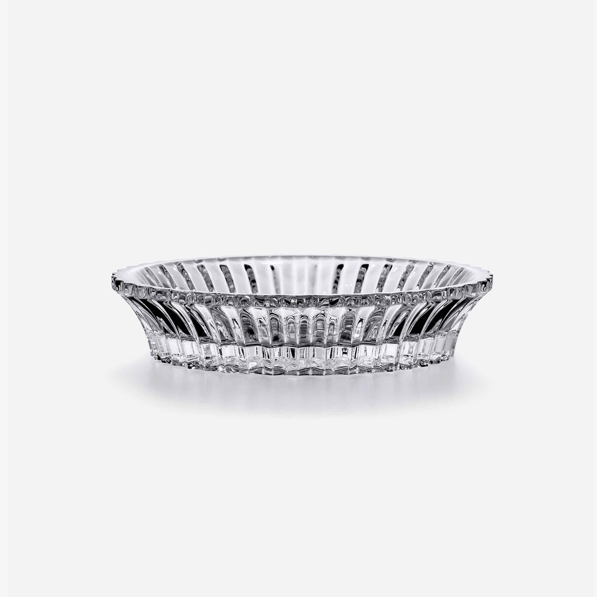 The Baccarat Mille Nuits Wine Coaster is a clear, round crystal dish with vertical ridges, flaring at the rim and narrowing at the base, displayed on a plain white background.