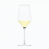 A clear Zalto White Wine Glass by Grand Cru Selections / Zalto, featuring a long stem and partially filled with pale yellow wine, is set against a plain white background.