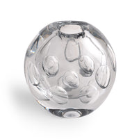 The Whitney Vase by FlowDecor Inc. is crafted from clear glass and features round indents on its surface, creating a contemporary look reminiscent of a decorative paperweight, shown here photographed against a white background.