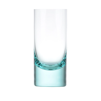 The Moser Whiskey Spirit Glass stands upright against a plain white background, featuring clear crystal with a thick, subtly blue-tinted base.