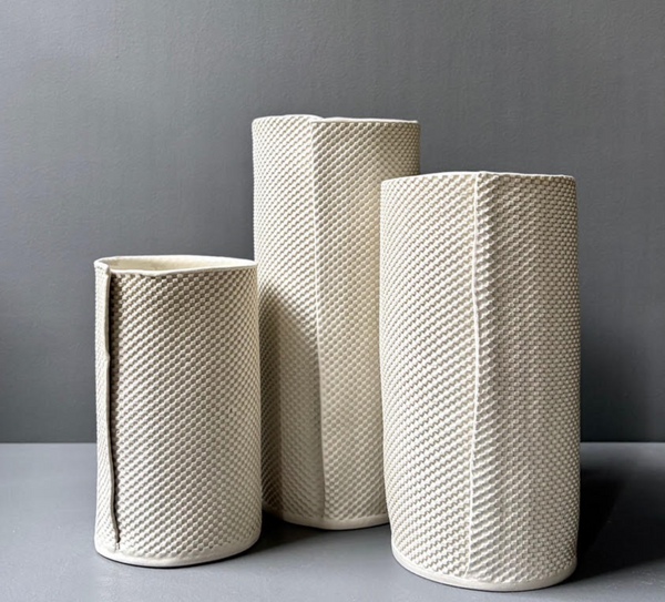 Three Pixel Cylinder Vase Cream porcelain vases, each cylindrical with a cream-colored, grid-textured, pixel-like surface pattern.