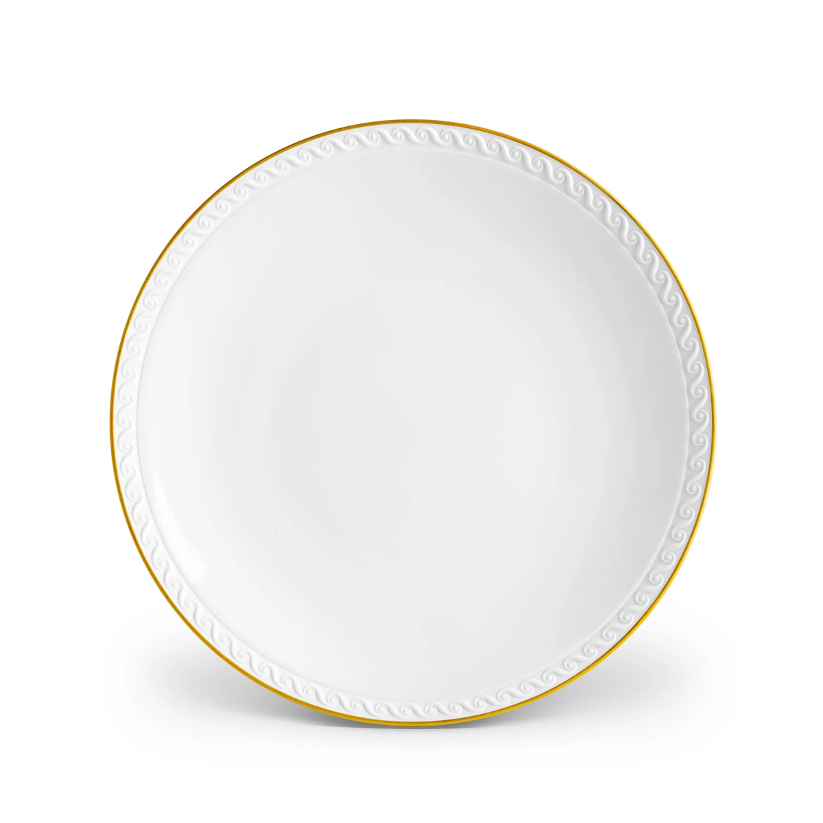 The L’Objet Neptune Gold dinnerware plate is crafted from fine white porcelain with a 24k gold rim and a textured wave pattern along the edge, displayed against a white background.