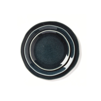 Three Maguelone Midnight Blue ceramic plates by Jars - Rosenthal are stacked in different sizes and viewed from above on a white background.