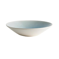 The Vuelta Atoll by Jars - Rosenthal is a modern, shallow round ceramic bowl featuring a white exterior and gradient blue interior, elegantly photographed on a white background.