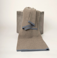 Hangai Mountain Textiles Yak Ribbed Throw - Platinum & Slate in tan with a grey border, draped over a grey cube.
