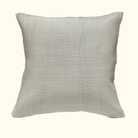 The Leather Weave Pillow Ivory by Threads Soft Goods is a square, textured throw pillow with woven ivory leather, shown against a plain beige background.