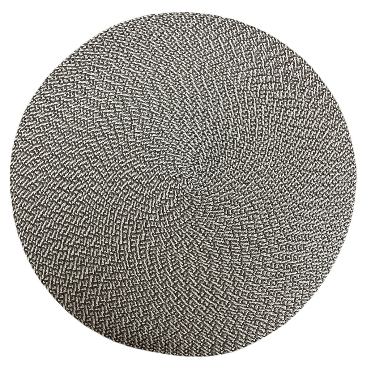The Deborah Rhodes Ikat Weave Round Placemat Granite Set of 4 features a tightly woven black and white spiral pattern, inspired by the Ikat collection.