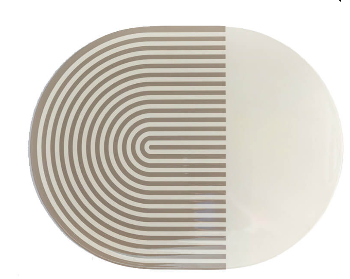 The Von Gern Home Stripes & Solids Lacquer Placemat Set of 4 features oval placemats with a bold beige and white color-blocked design—half with curved beige stripes, half solid white—for a modern table setting.