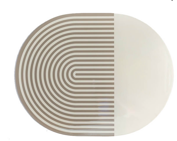 The Von Gern Home Stripes & Solids Lacquer Placemat Set of 4 features oval placemats with a bold beige and white color-blocked design—half with curved beige stripes, half solid white—for a modern table setting.