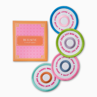 The Bullseye Mah Jong Cocktail Napkin Set by Oh My Mahjong features colorful round napkins with Mahjong-inspired designs and phrases, packaged in a pink and orange box—perfect for adding playful flair to any gathering.