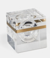 The Gemma Box by Luho is a clear acrylic decorative box with a gold horizontal stripe and a round lens in the center—perfect as a modern luxury decor accent. Displayed on a light background.