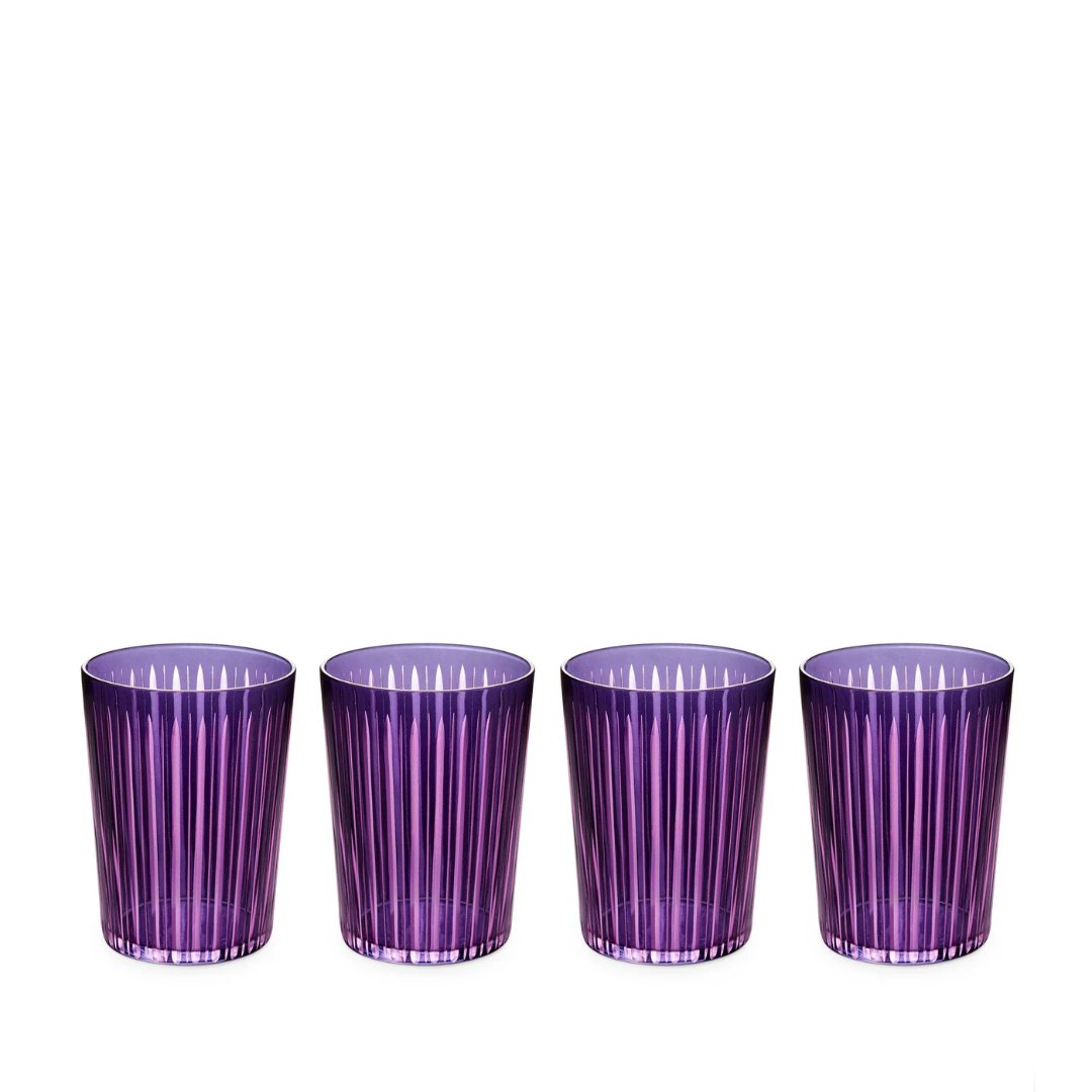 Four purple Prism Highball Glasses from L'Objet are lined up on a white background. Stylish, modern, and dishwasher-safe, this set of 4 adds a vibrant touch to any table.