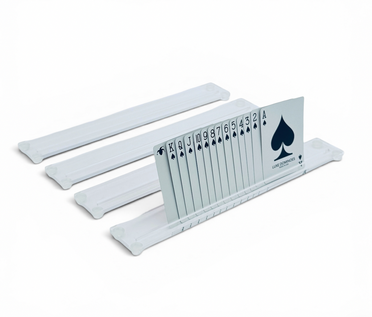 A Luxe Dominoes Luxe Canasta & More Card Racks Set of 4 displays a complete spade suit arranged from ace to king, with three empty white card holders placed behind it on a white surface.