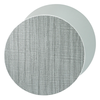 The Bodrum Izmir Placemat Round s/4 features a modern design with two overlapping circular panels—one with a textured light gray fabric pattern in front and a smooth, solid light gray panel at the back.