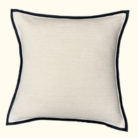 The Threads Soft Goods Leather Frame Pillow Ivory is a square ivory accent pillow featuring subtle textured fabric and a slim leather border, displayed against a light background.