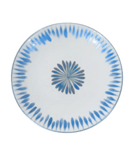 The Marie Daage Allee de Cypres 4 by Marie Daâge is a round white Limoges porcelain plate featuring a symmetrical blue petal pattern radiating from the center and forming a ring near the edge—a true piece of luxury tableware.