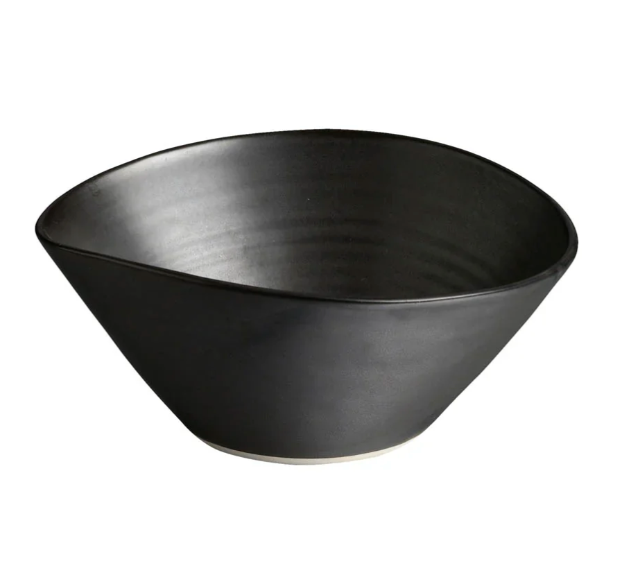The Simon Pearce Barre Dinnerware Slate features a matte black, wide-rimmed stoneware bowl with a smooth finish and slightly off-white base, shown against a plain white background.