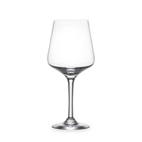 A clear, empty wine glass with a long stem and wide bowl from the Simon Pearce Vintner Stemware collection is displayed against a plain white background.