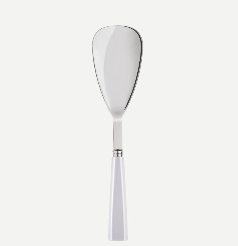 The Sabre Icone Rice Spoon White by Sabre features a wide, flat, slightly curved stainless steel blade and a white handle, shown against a plain white background.