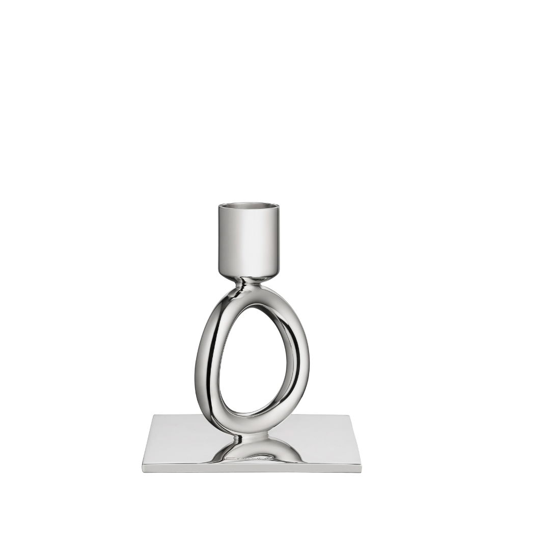 The Christofle Vertigo Silver Plated Candlestick features a modern oval loop on a square base, showcased against a plain white background.