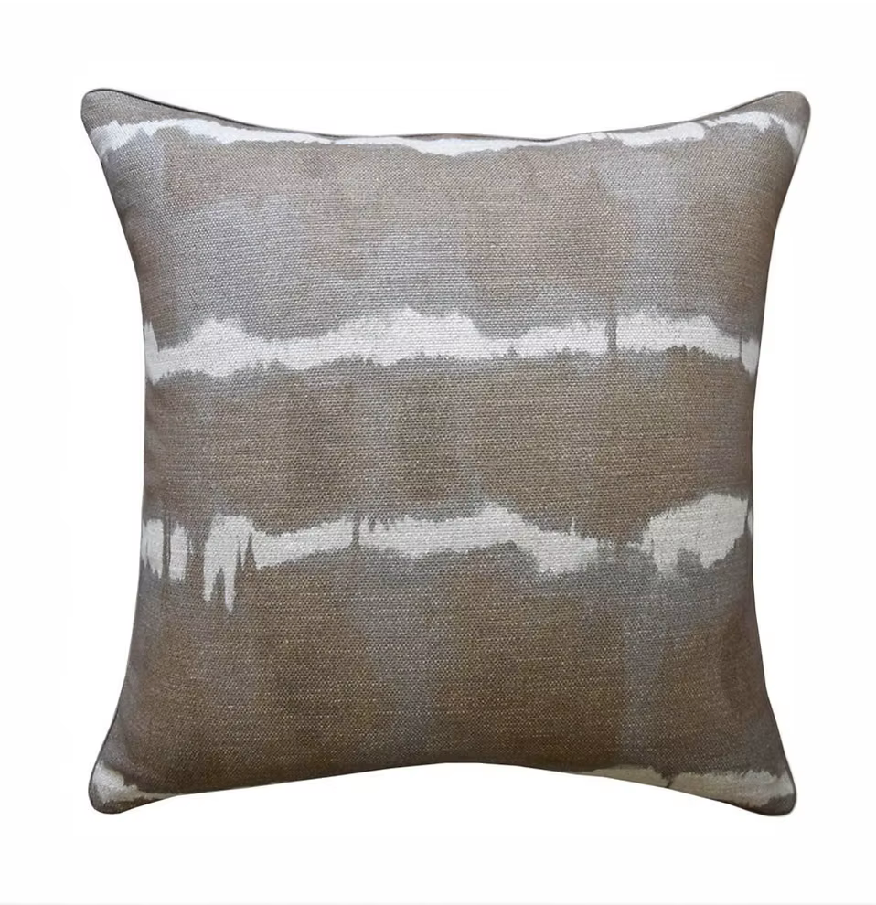The Baturi Pillow Mist 23 x 23 by Decorum is a square decorative pillow featuring a brown and gray textured background with horizontal white streaks reminiscent of a watercolor or tie-dye effect. The pillow is photographed against a plain white backdrop.