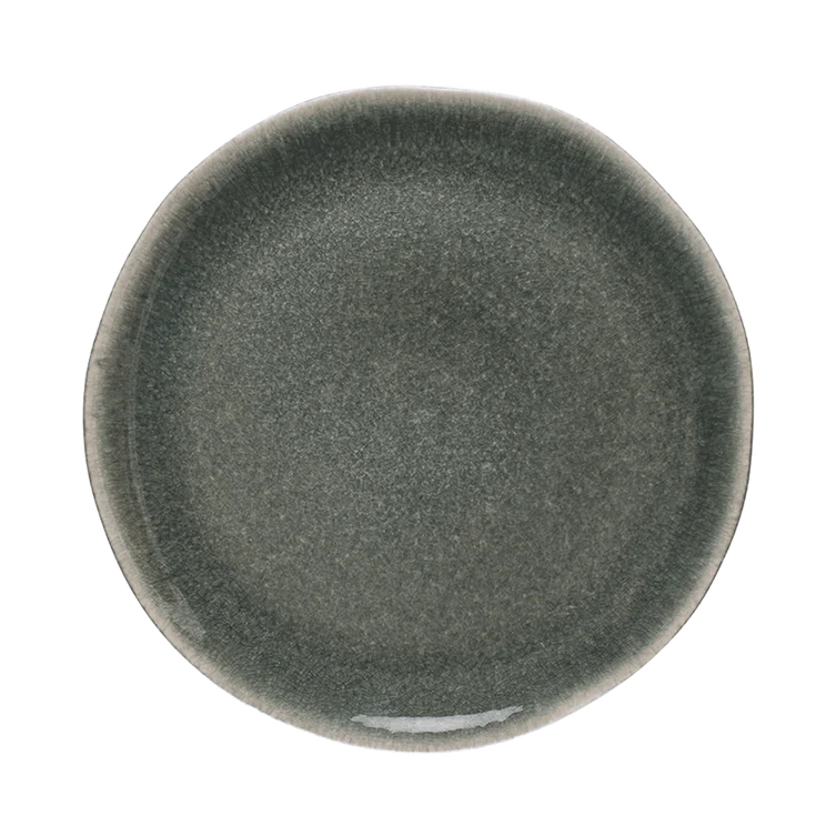The Maguelone Orage Dinnerware by Jars - Rosenthal features a round, dark gray handcrafted stoneware plate with a subtly irregular rim and gradient pattern, shown against a plain light background.