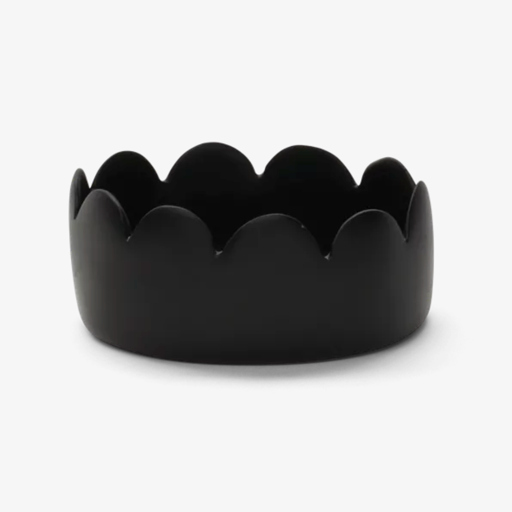 Fleur Oval Bowl Black by Tina Frey—an elegant, handcrafted resin bowl featuring an oval silhouette and distinctive scalloped edge, beautifully photographed against a plain white background to highlight its refined design.